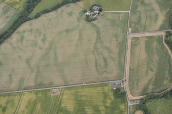 Oblique aerial view centred on the cropmarks of Stracathro Roman temporary camp, looking NE.