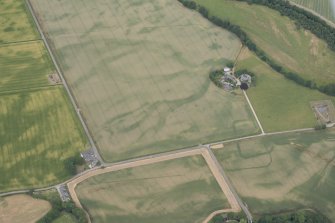 Oblique aerial view of the cropmarks of Strathacro Roman temporary camp, looking NW.