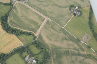 Oblique aerial view of the cropmarks of Strathacro Roman fort and temporary camp, looking SW.