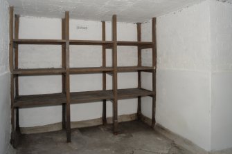 Interior, general view of wine cellar showing wine racks from South.