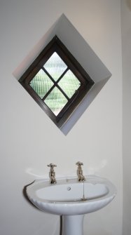 Interior, detail of washbasin and window in cloakroom.