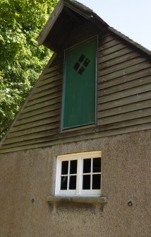 Exterior, detail of door into hayloft.