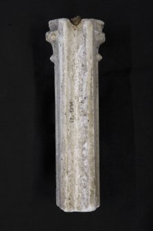 View of reverse of composite pillar from corner of tombchest, showing rebate