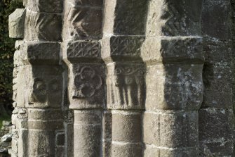 Exterior. South doorway. Detail of south west grouping of inner facing capitals heads.