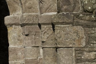 Exterior. South doorway. Detail of north east grouping of outer facing capitals heads.