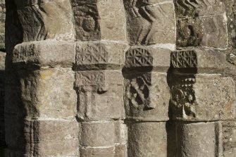 Exterior. South doorway. Detail of south west grouping of inner/outer facing capitals heads.