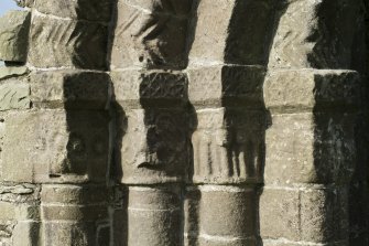 Exterior. South doorway. Detail of north east grouping of inner/outer facing capitals heads.