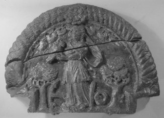A carving of the virtue of Hope (DP00/081, 083). It is a semicircular panel which would have formed a central feature of the decorated stern. Hope is depicted as a draped female figure holding one of her attributes, a crow. The other attributes are two oak trees, signifying strength, and an anchor—anchora spei—the anchor of hope. (Colin Martin)