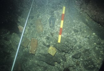 Bricks and tile fragment from the collapsed galley structure at the forward end of the wreck. Scale 25 centimetres. (Colin Martin)
