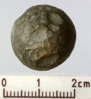 Lead musket ball with its surface roughened by blows with a blunt implement to create a ‘dum-dum’ effect. Scale in centimetres. (Colin Martin)