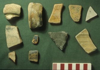 Water-worn pottery derived from the ship’s gravel ballast, and believed to have been brought aboard while ballasting. None is of types identified elsewhere on the ship. They include Spanish olive jar ware (left) and other wares thought to be of Continental origin. Scale 10 centimetres. (Colin Martin)