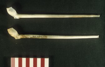 Complete tobacco pipes (DP00/147, 02/007) bearing the heel-mark ‘NW’, a Newcastle maker. Scale 10 centimetres. (Colin Martin)