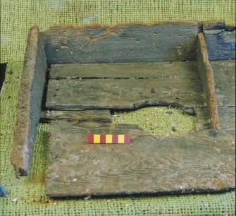 The binnacle (DP96/004) – the left-hand compartment. The damaged round hole may have been to illuminate the left-hand compass during the day. Scale 7 centimetres. (Colin Martin)