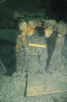 Front view of inverted wooden gun-carriage (DP00/013) associated with Gun 8 (DP00/203) after excavation. Scale 15 centimetres. (Colin Martin)