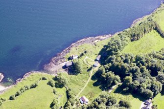 Aerial photograph of the kiln complex at Port Kilcheran from the N. The quarry face is visible beneath the line of trees facing the sea. The former seminary, now Kilcheran House, is at bottom right. (Colin Martin)