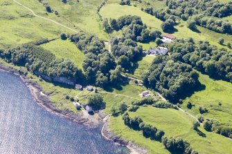 Aerial photograph of the kiln complex at Port Kilcheran from the NE. The quarry face is beneath the line of trees facing the sea. The former seminary, now Kilcheran House, is upper right of centre. (Colin Martin)