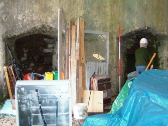 Interior of the shed fronting Kiln B, showing the inner right and left draw-arches of the two pots. (Paula Martin)
