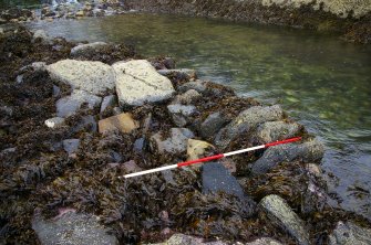 A segment of laid foundation stones among the tumbled remains of the low-water quay. (Colin Martin)