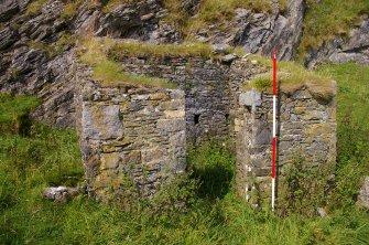 Small building set against the quarry face within a walled enclosure 40 m SW of the kiln complex. It is probably an explosives magazine. Scale 2 metres. (Colin Martin)