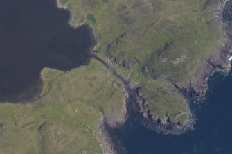 Aerial photograph of the headland fort and canal from the SW. Underwater indications of a stone-built quay can be seen on either side of the canal’s entry to the loch. Beyond the canal entrance a basin of deeper water largely clear of weed is visible. (Colin Martin)