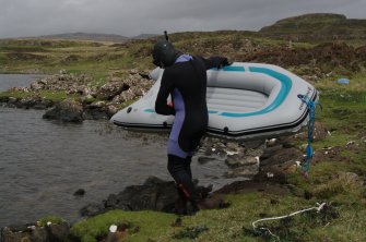 Attempts have been made to search the shallow loch bed, since it is likely that further early boat components will be found there. The simplest method has been to use a small inflatable raft pulled along rope lanes stretched across the loch by a snorkeller. (Colin Martin)