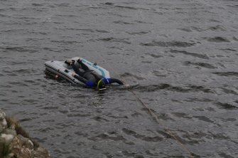 Attempts have been made to search the shallow loch bed, since it is likely that further early boat components will be found there. The simplest method has been to use a small inflatable raft pulled along rope lanes stretched across the loch by a snorkeller. (Colin Martin)