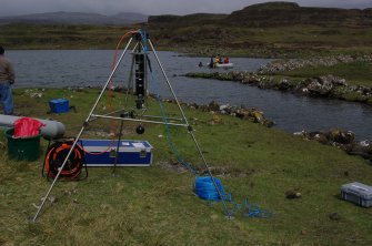 Trials have been made using sector scanning to search the loch bed for archaeological features. The equipment is seen here assembled and ready for launching. (Colin Martin)