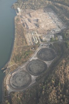 General oblique aerial view of the remains of Inverkip power station during post-demolition clearance, looking to the NNE.