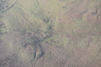 Oblique aerial view of the remains of the farmstead, looking to the WNW.