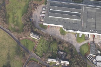 Oblique aerial view of the factory and Old Erskine Parish Church, looking to the NNW.