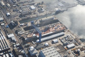 Oblique aerial view of Rosyth Dockyard showing the construction of the new aircraft carrier, HMS Queen Elizabeth, looking SE.