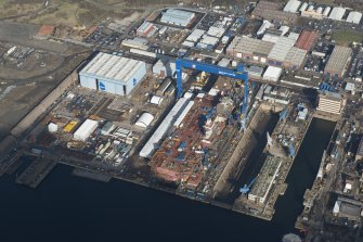 Oblique aerial view of Rosyth Dockyard showing the construction of the new aircraft carrier, HMS Queen Elizabeth, looking N.