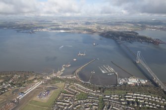 General oblique aerial view of the construction of the new Queensferry, the Forth Road Bridge and Port Edgar, looking NNE.