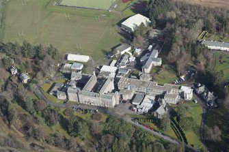 Oblique aerial view of Queen Victoria School, looking NE.