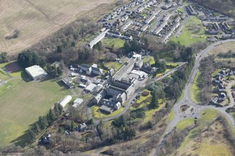 Oblique aerial view of Queen Victoria School, looking SE.