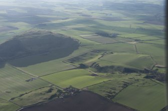 Oblique aerial view over Kippielaw farmstead towards Traprain Law and Hairy Craig, looking to the SW.