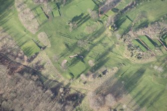 Oblique aerial view centred on part of the disused race course, the farmstead and the golf course, looking N.