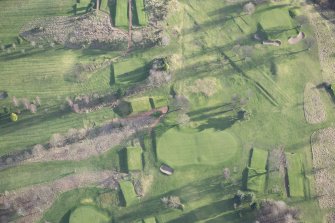 Oblique aerial view centred on part of the disused race course, the farmstead and the golf course, looking SSE.