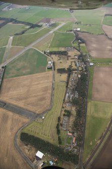 General oblique aerial view of the airfield technical site and former hospital, looking W.
