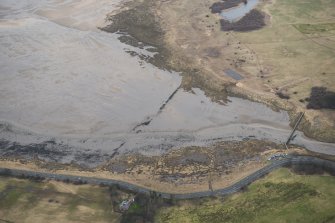 Oblique aerial view of remains of anti-tank blocks and footbridge, looking NE.