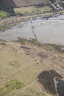 Oblique aerial view of remains of anti-tank blocks, looking NE.