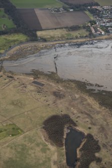 General oblique aerial view of remains of anti-tank blocks and footbridge, looking S.