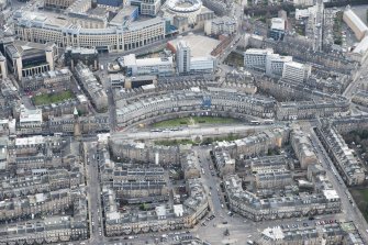 Oblique aerial view of Atholl Crescent, Coates Crescent and the Edinburgh Tramway with a running tram, looking SE.