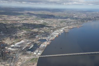 General oblique aerial view of the Dundee waterfront showing Taybridge Railway Station and the site of the former Olympia Swimming Pool and Leisure Centre, looking E.