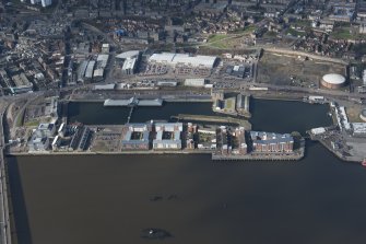 Oblique aerial view of Victoria and Camperdown Docks, looking NW.