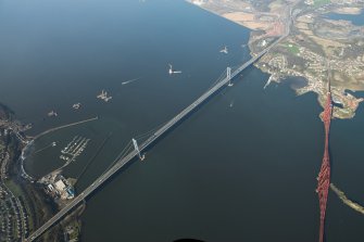 Oblique aerial view of the Forth Bridge, Forth Road Bridge and Queensferry Crossing construction, looking to the NNW.