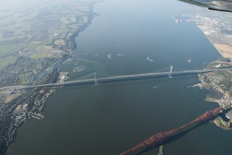 Oblique aerial view of the Forth Bridge, Forth Road Bridge and Queensferry Crossing construction, looking to the W.
