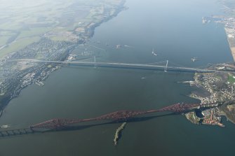 Oblique aerial view of the Forth Bridge, Forth Road Bridge and Queensferry Crossing construction, looking to the WSW.