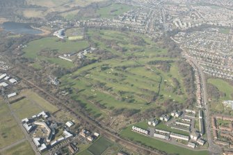Oblique aerial view of Duddingston House and golf course and Holyrood Roman Catholic Secondary School, looking to the N.