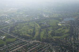 Oblique aerial view of Duddingston House and golf course and Holyrood Roman Catholic Secondary School, looking to the SW.